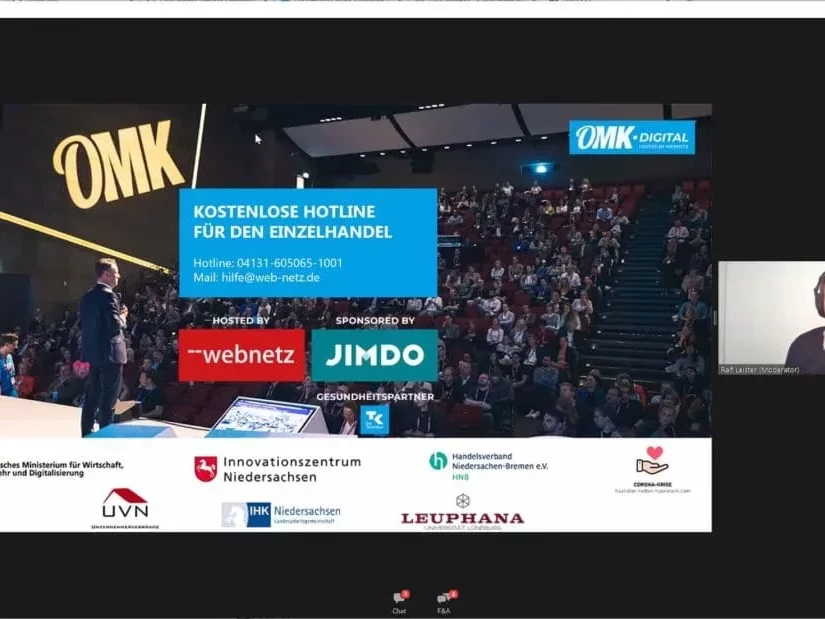 Screenshot der Videokonferenz OMK.digital mit Präsentation und Moderator.