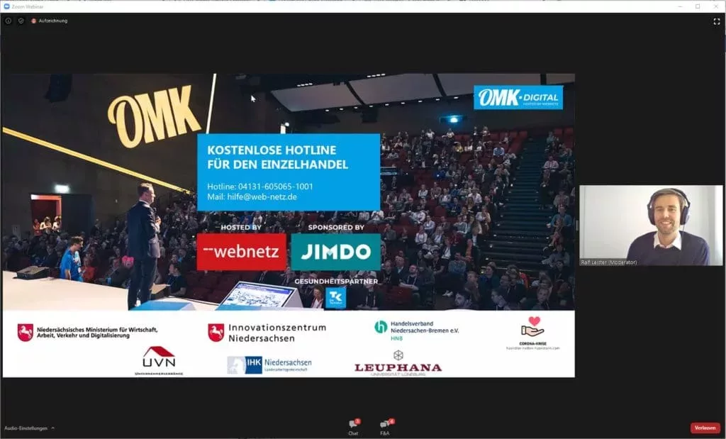 Screenshot der Videokonferenz OMK.digital mit Präsentation und Moderator.