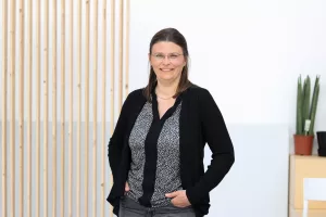 Das Bild zeigt Frau Dr. Lena Oesterlin-Meret vor einer weißen Wand.